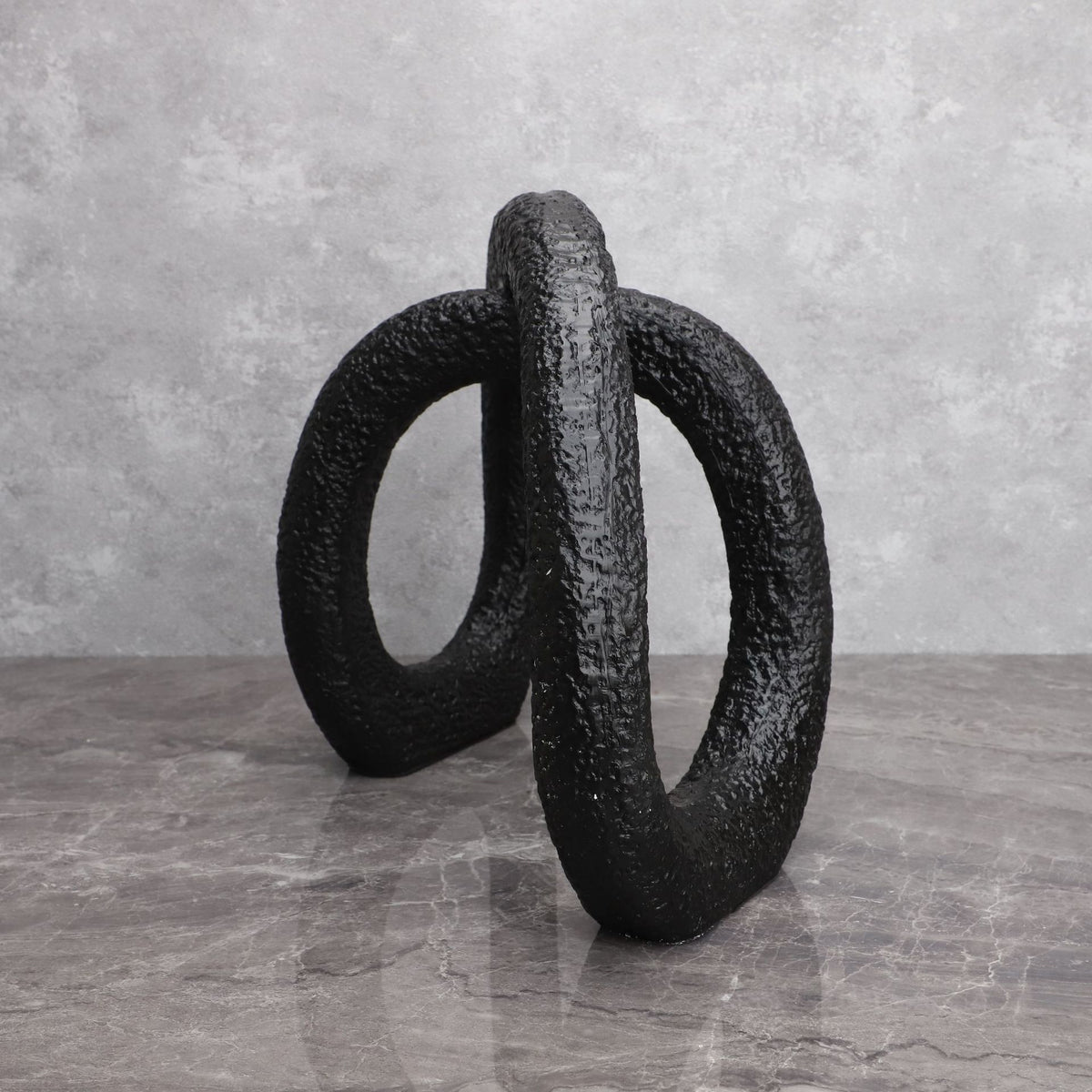 Black infinity loop decor with textured matte finish for modern interiors