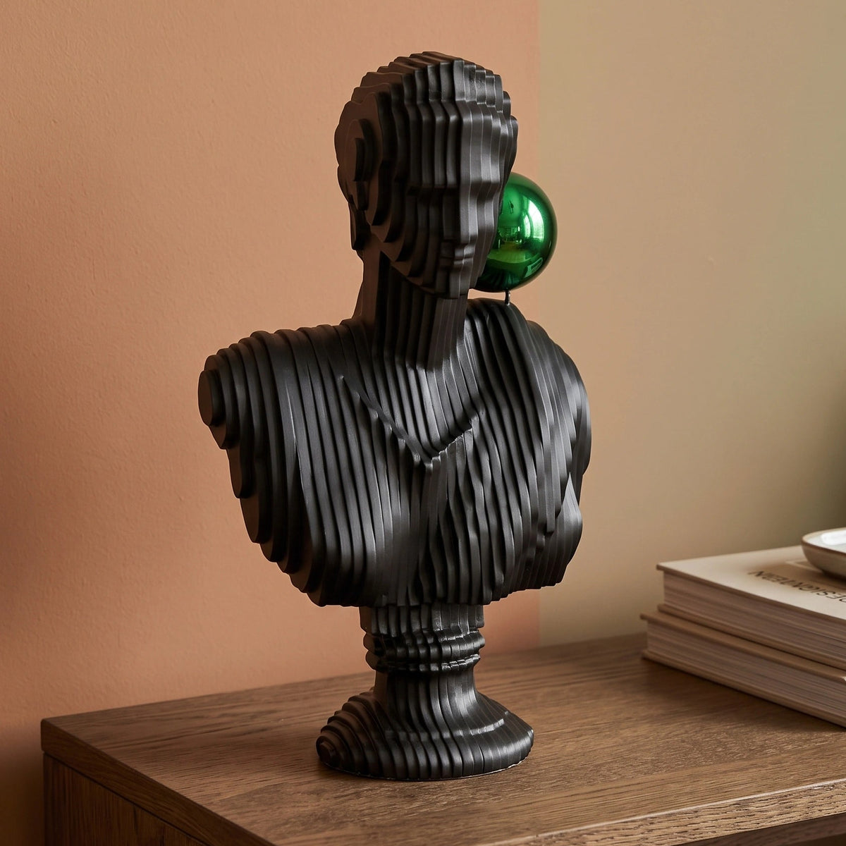 Matte black modern bust sculpture featuring an abstract human face design for luxury contemporary home décor
