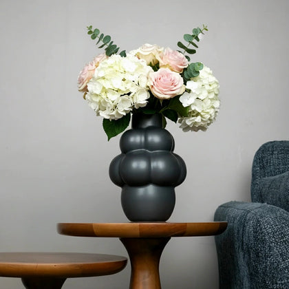Luminara black vase w/ pink roses, side table