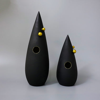 Abstract black decorative accent featuring gold details for contemporary home decor styling