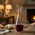 Modern handcrafted glass wine decanter carafe with artistic curved handle design for luxury dining, wine serving and contemporary bar decor