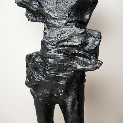 tall black sculpture human form living room statement piece