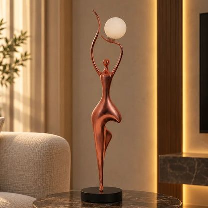 Rose gold lady lamp on green marble side table