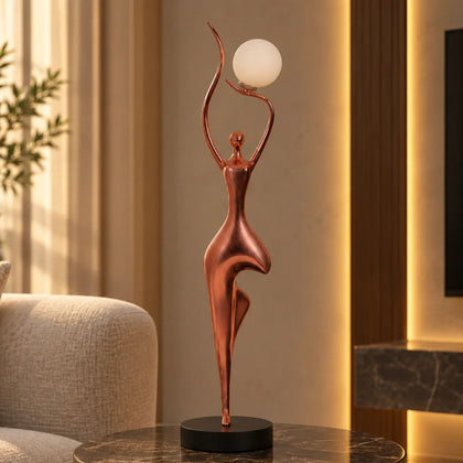 Rose gold lady lamp on green marble side table