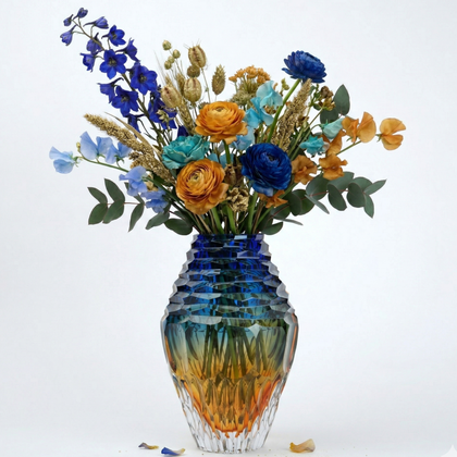 Colorful bouquet of flowers in a textured glass vase on a white background