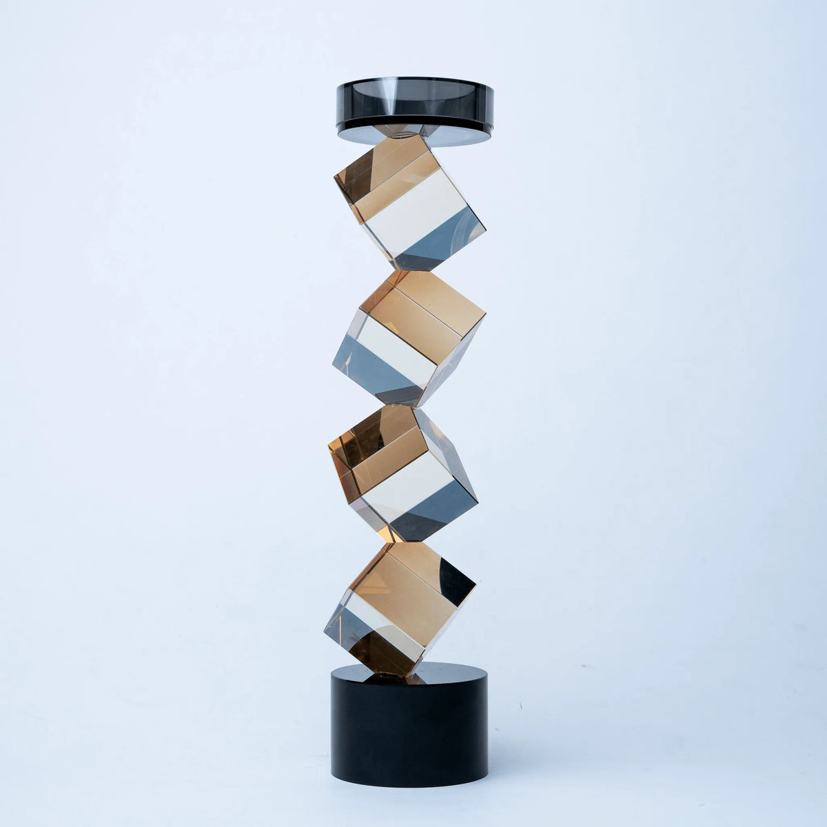 Geo Twist candle holder with faceted amber geometric design and black base