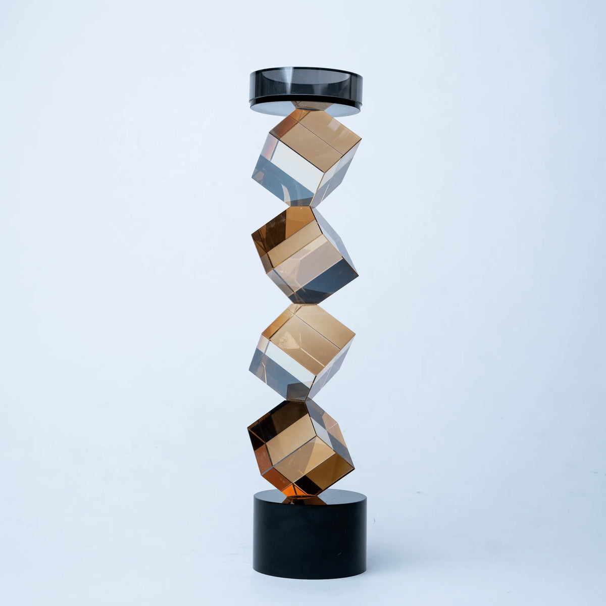 Contemporary twisted geometric candle holder in warm amber and black