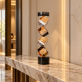 Contemporary twisted geometric candle holder in warm amber and black