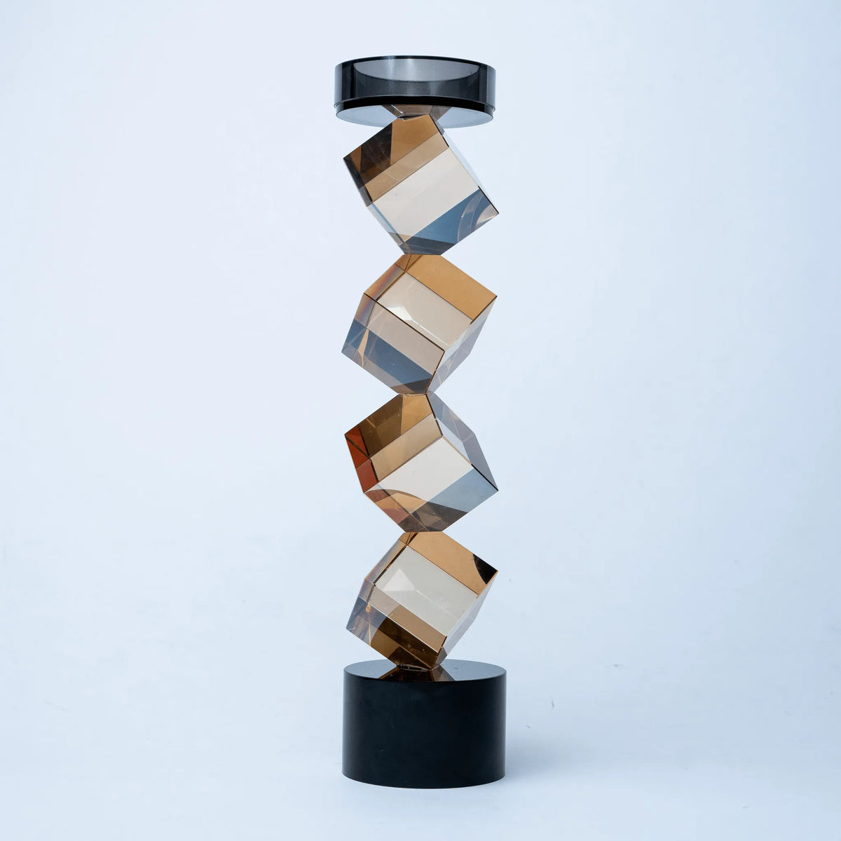 Contemporary twisted geometric candle holder in warm amber and black