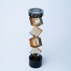 Contemporary twisted geometric candle holder in warm amber and black