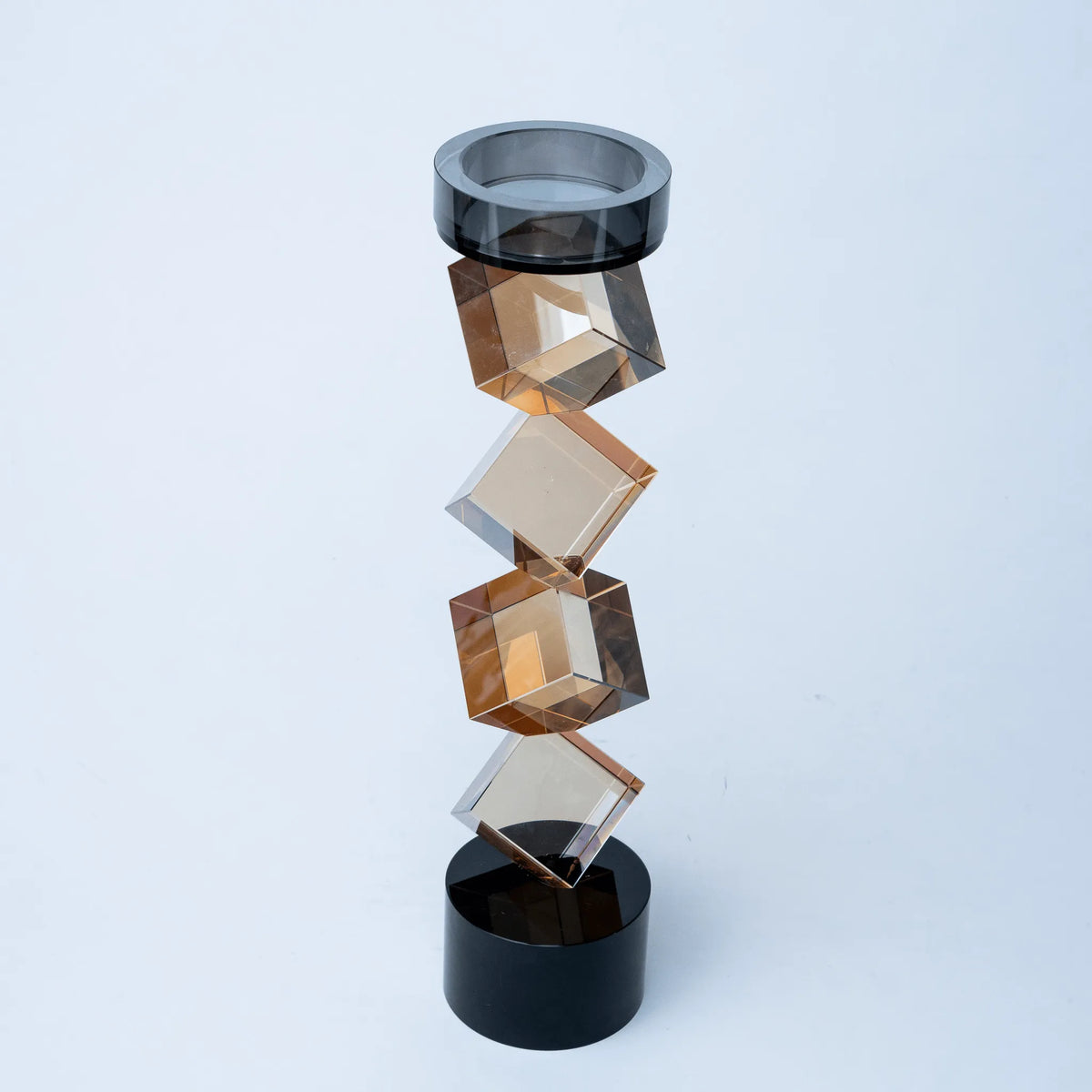 Contemporary twisted geometric candle holder in warm amber and black