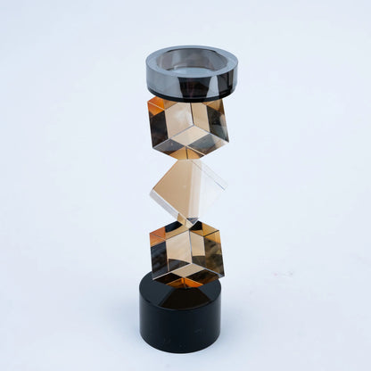 Faceted amber geometric candle stand with contrasting black cylindrical base