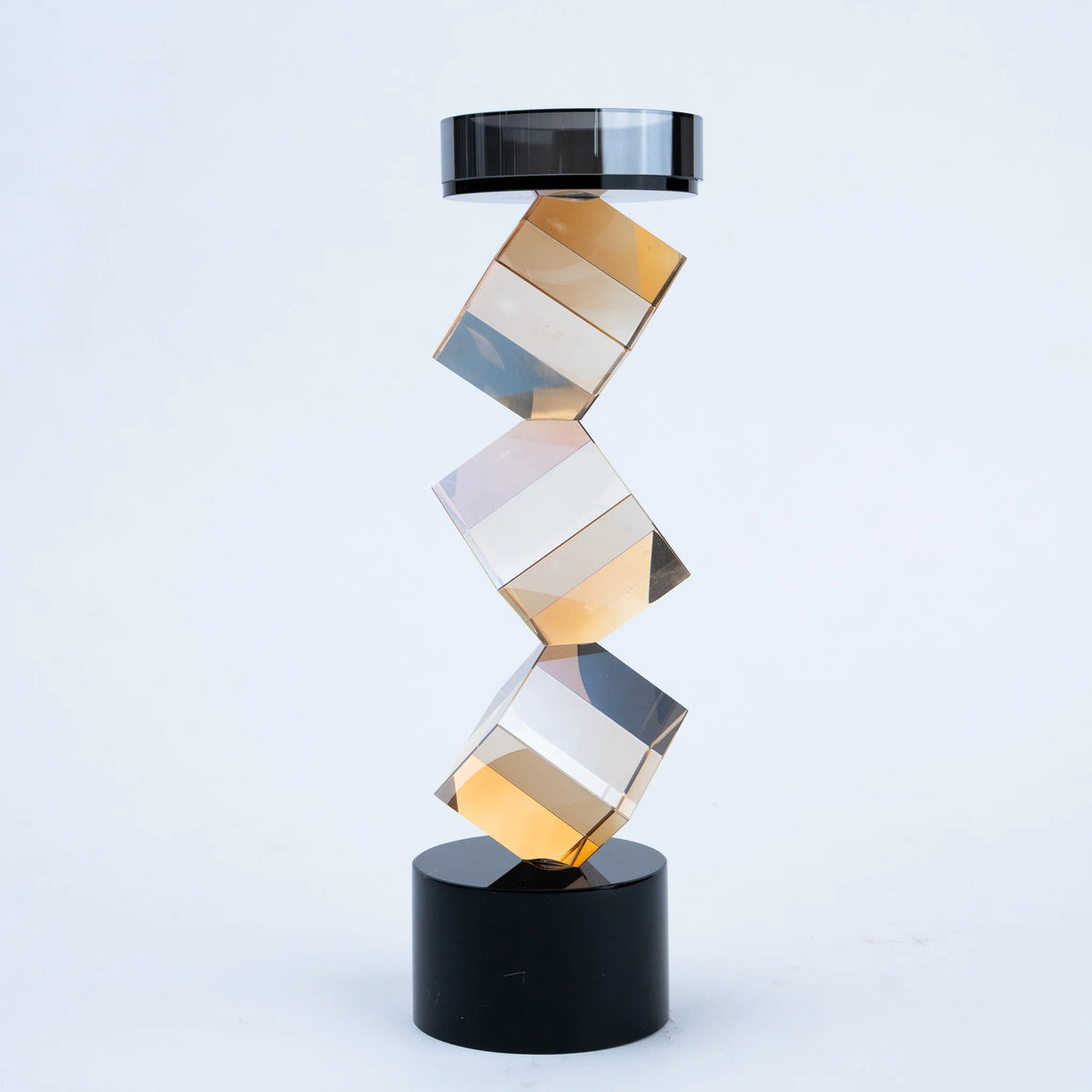 Modern tabletop candle holder with angular amber design and black base