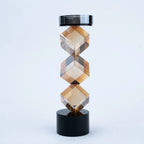 Modern tabletop candle holder with angular amber design and black base