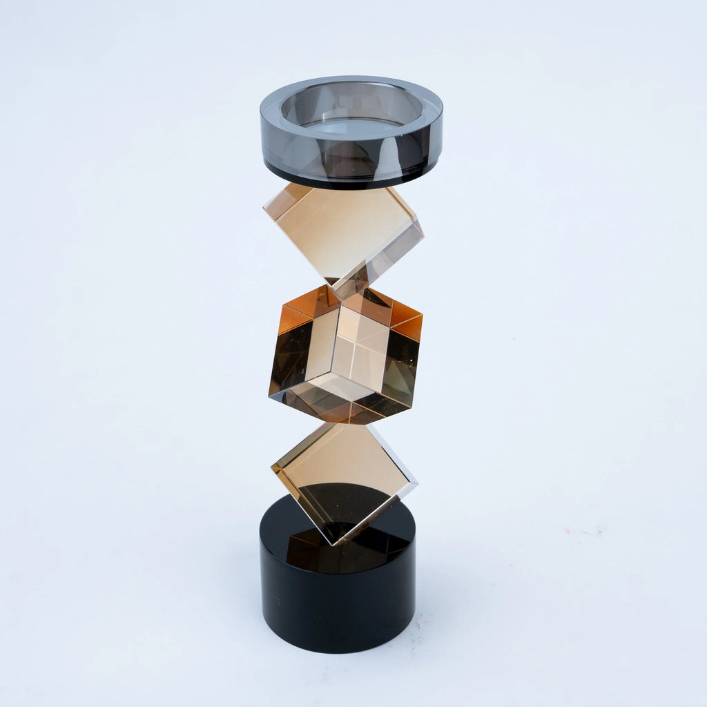 Abstract geometric candle holder with warm amber finish and black base