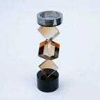 Abstract geometric candle holder with warm amber finish and black base