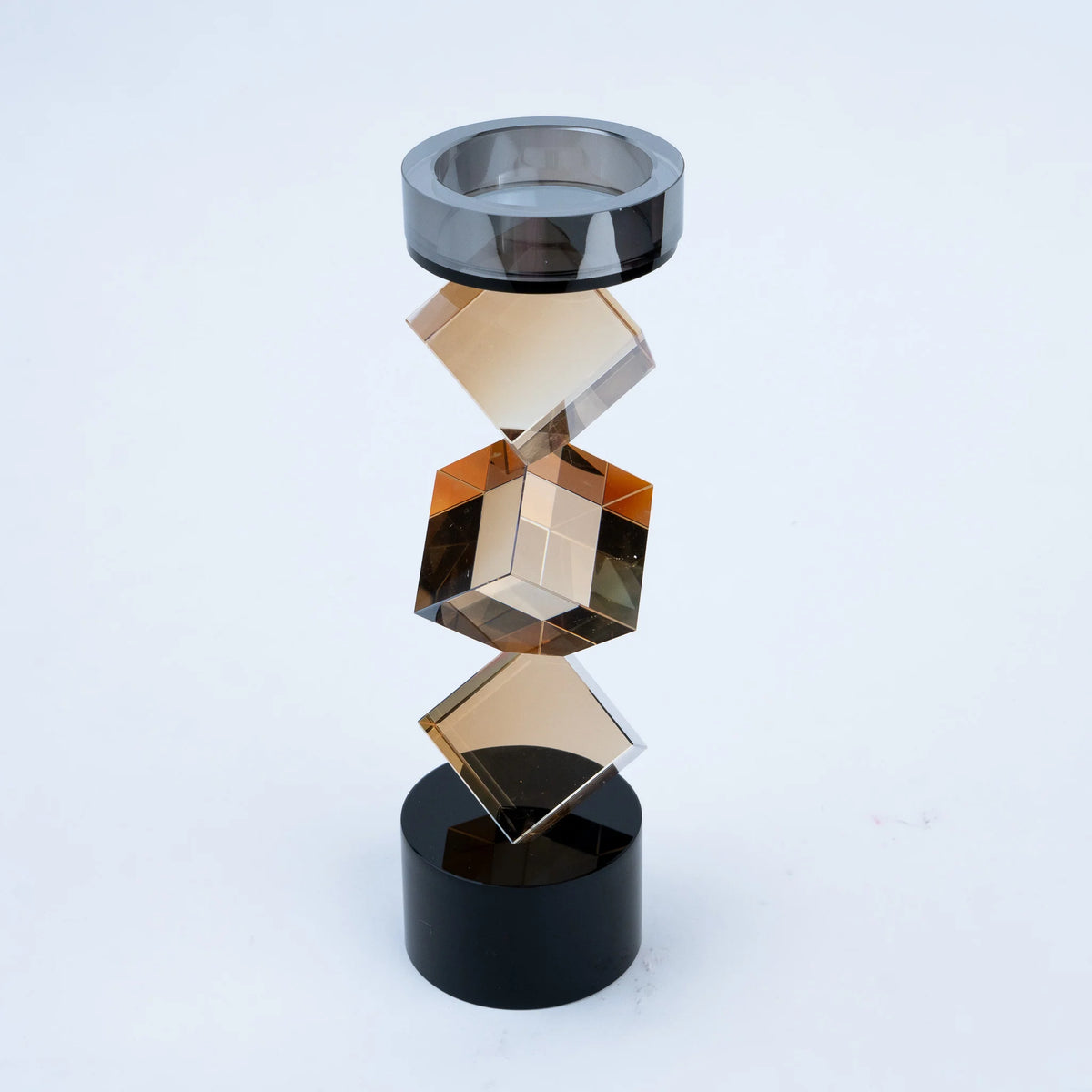 Abstract geometric candle holder with warm amber finish and black base
