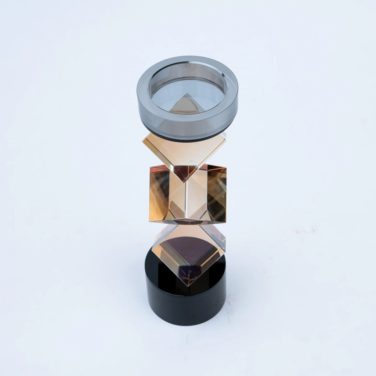 Luxury geometric candle stand with faceted amber-toned body
