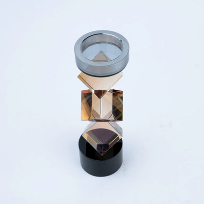 Luxury geometric candle stand with faceted amber-toned body