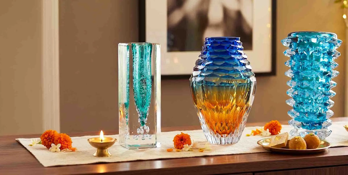 Collection of colourful glass vases in blue, turquoise and amber tones for festive home decor