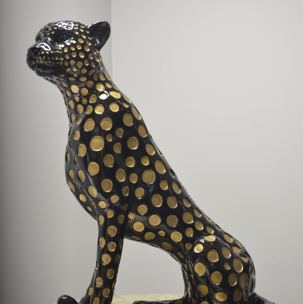 Black leopard decor object with silver spots and gold detailing