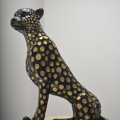 Black leopard decor object with silver spots and gold detailing