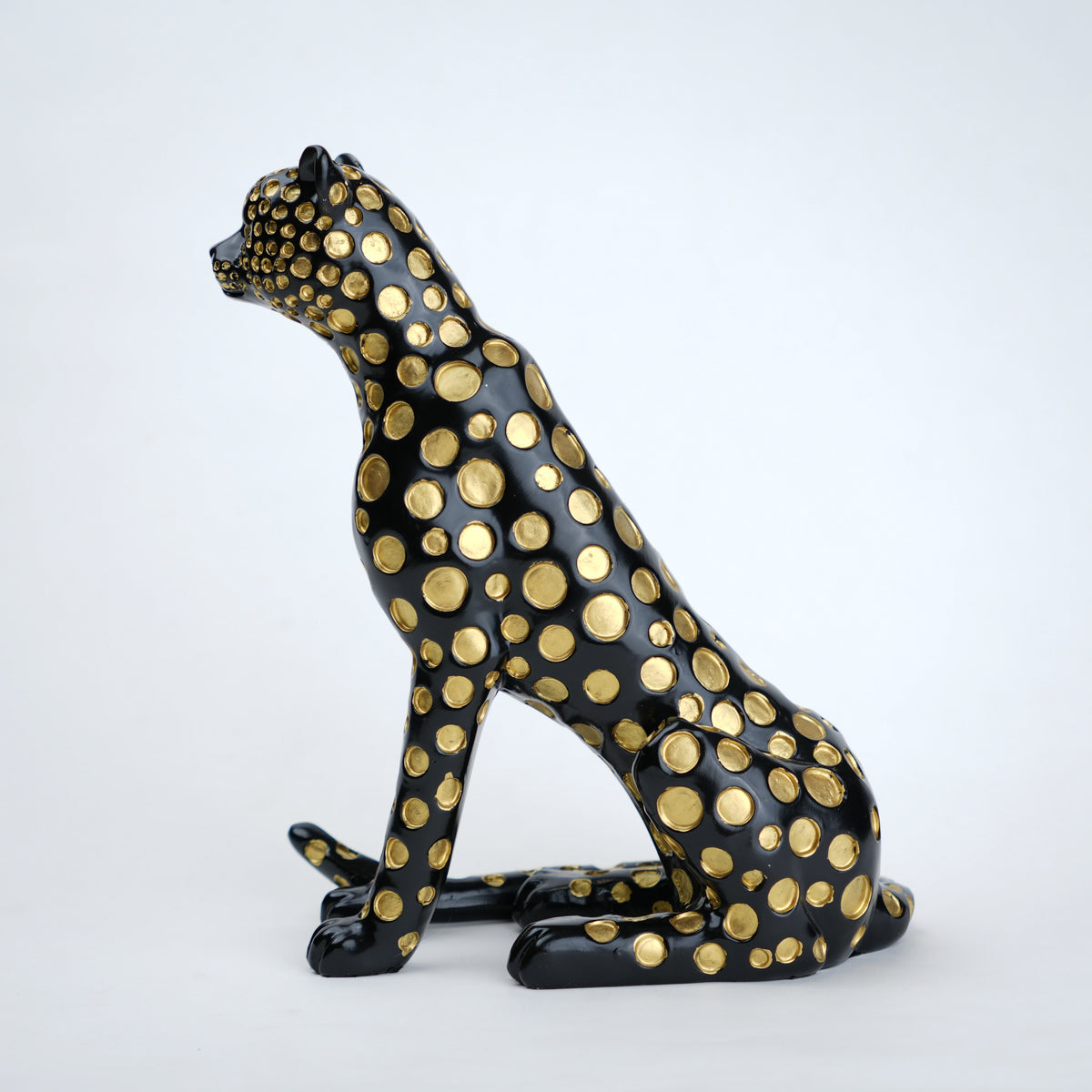 Black leopard decor object with silver spots and gold detailing