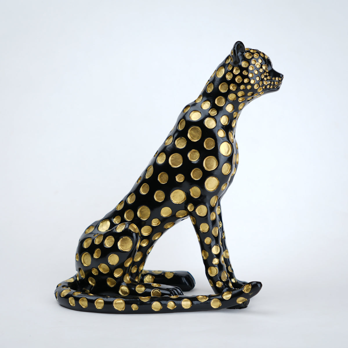 Black leopard decor object with silver spots and gold detailing