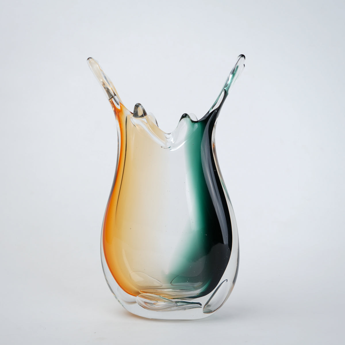 Green clear dual tone glass vase with an organic shape and uneven rim, featuring a thick base and smooth blended finish for modern home decor.