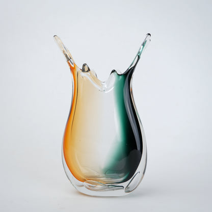 Green clear dual tone glass vase with an organic shape and uneven rim, featuring a thick base and smooth blended finish for modern home decor.