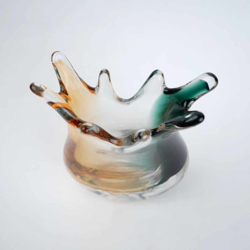 Green yellow glass vase with flowing curved edges