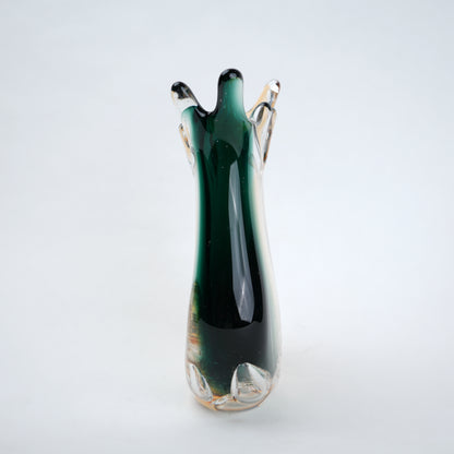 Green glass vase with a unique design on a white background