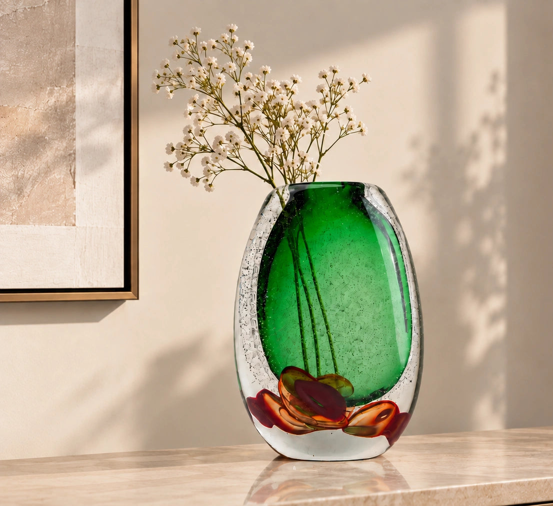 Decorative glass piece with green center and red and brown floral design on a white background