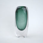 Decorative art glass vase with green gradient center encased inside clear glass body.