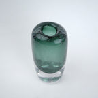 Decorative art glass vase with green gradient center encased inside clear glass body.