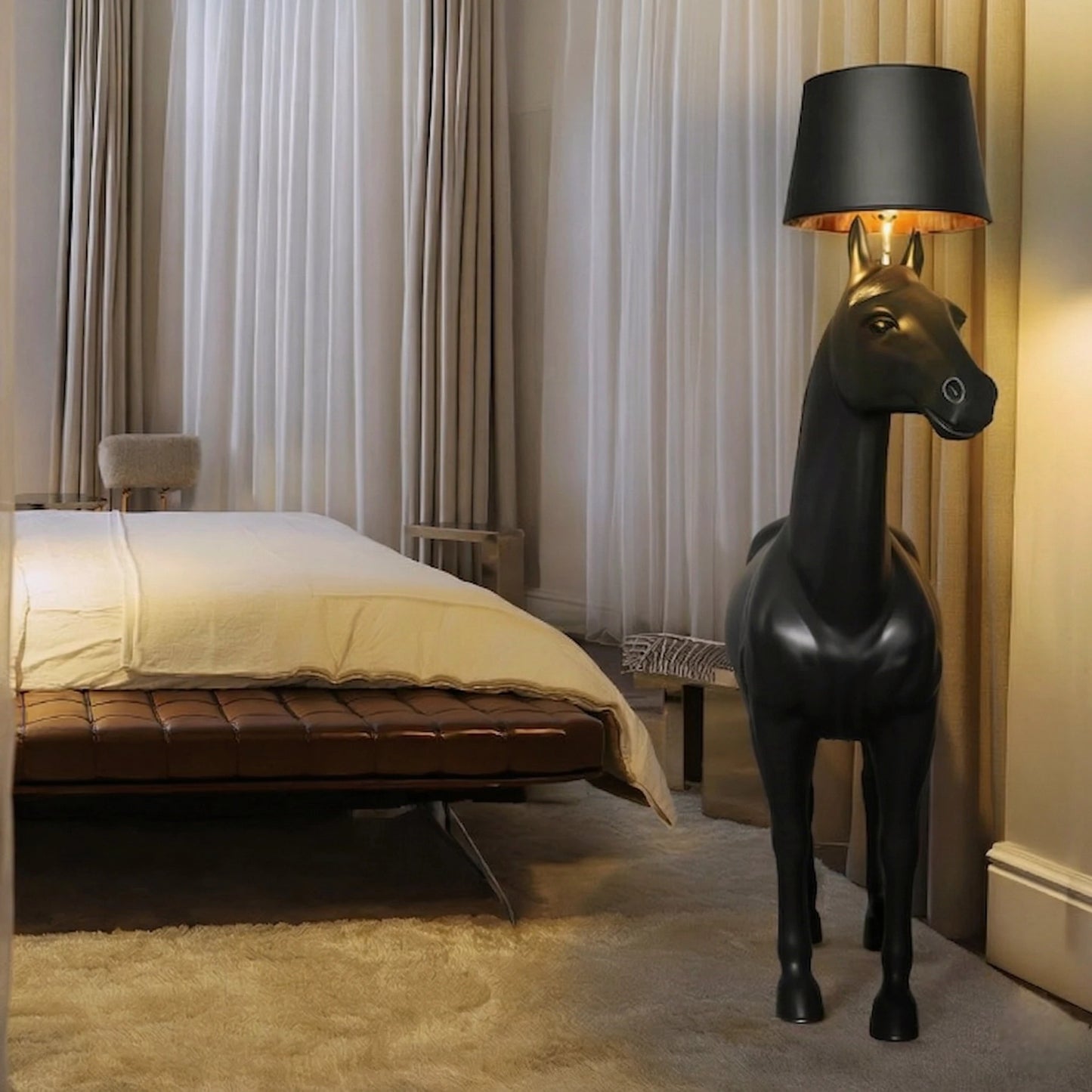 Decorative horse-shaped lamp in a bedroom setting with curtains and bed.