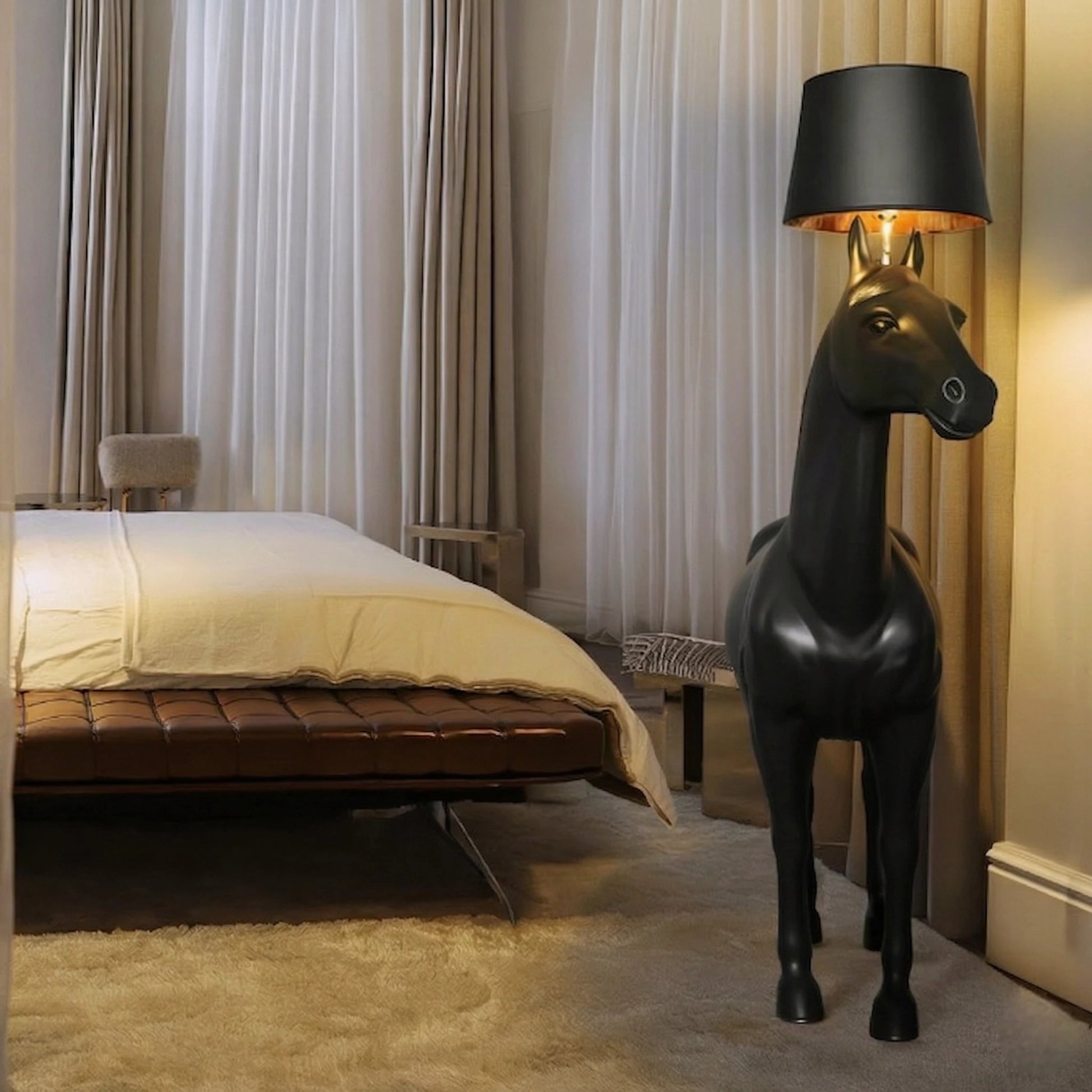 Decorative horse-shaped lamp in a bedroom setting with curtains and bed.