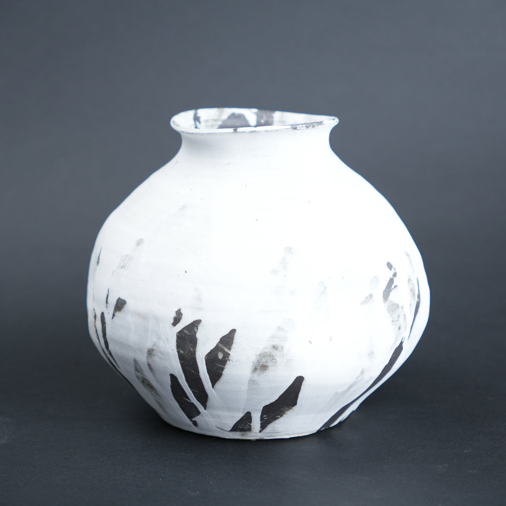 Round ivory ash vase, dark grey backdrop