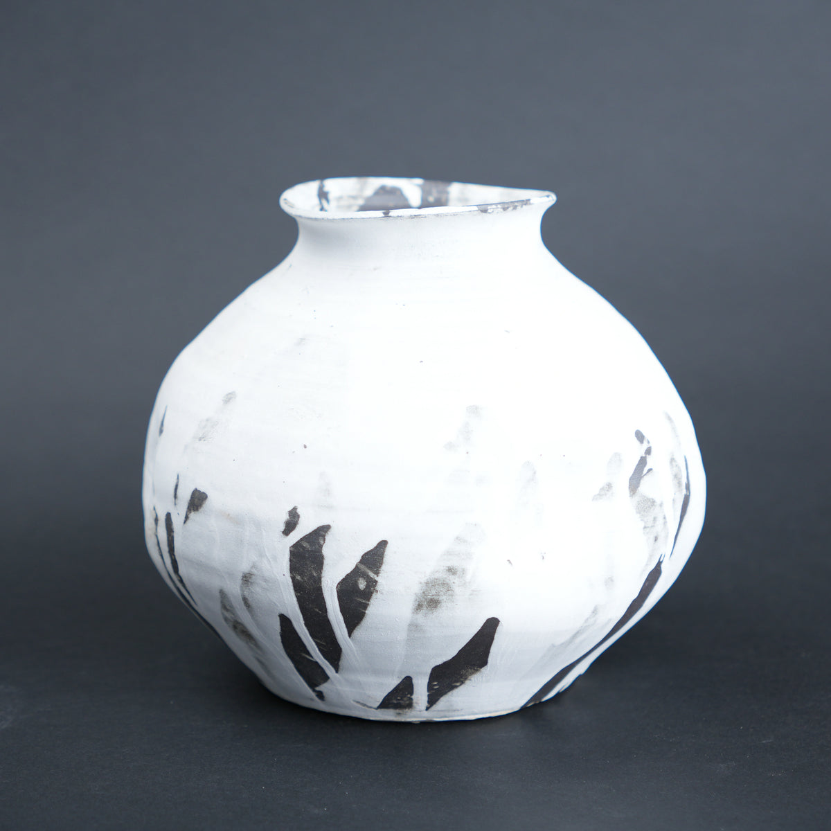 Round ivory ash vase, dark grey backdrop