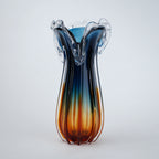 Glass vase with blue and orange gradient on a white background