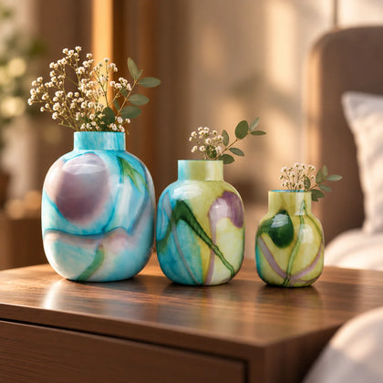 Blue marble effect glass vase with a smooth glossy finish, featuring a rounded body and short cylindrical neck, designed as a modern decorative piece for home decor styling.