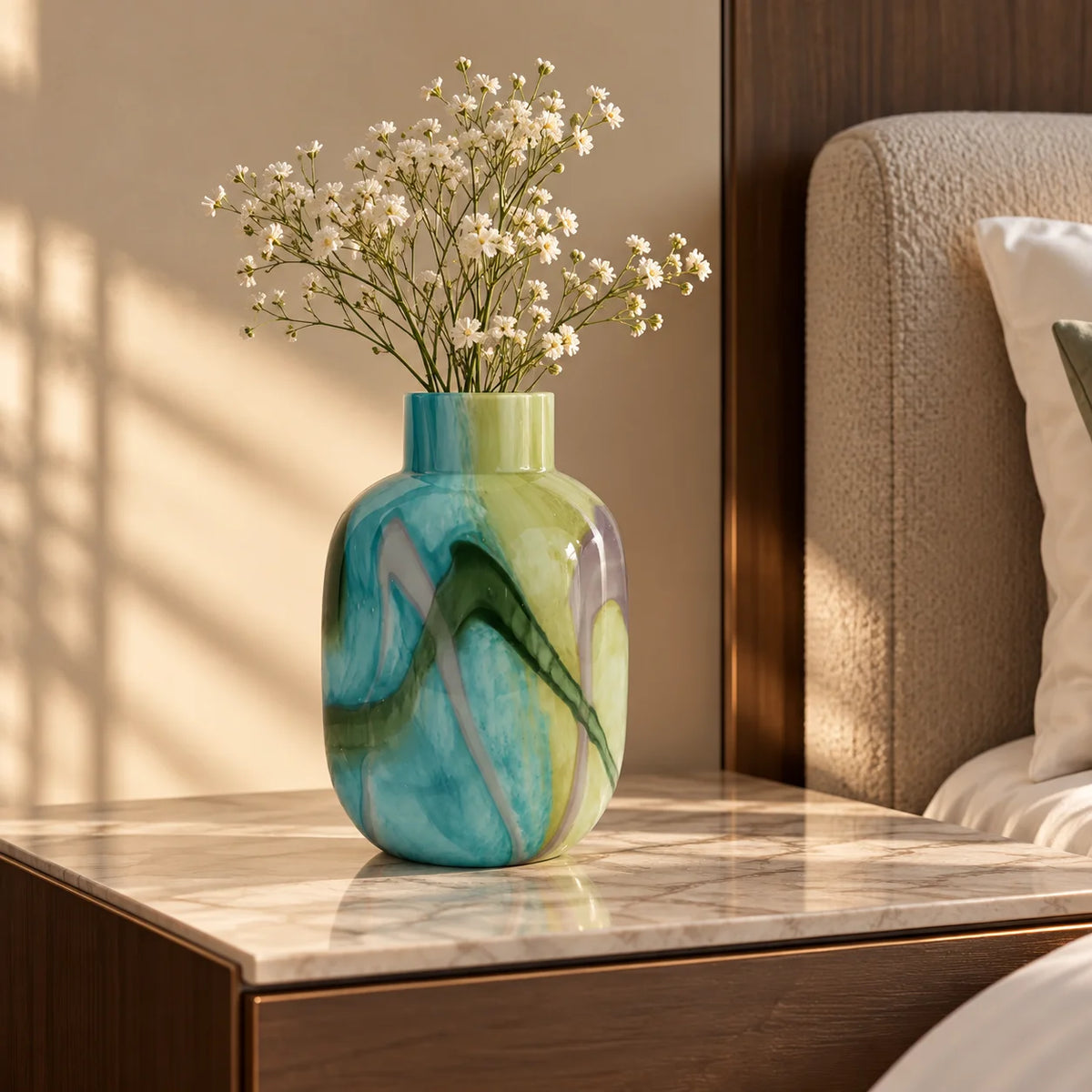 Blue marble effect glass vase with a smooth glossy finish, featuring a rounded body and short cylindrical neck, designed as a modern decorative piece for home decor styling.