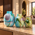Blue marble effect glass vase with a smooth glossy finish, featuring a rounded body and short cylindrical neck, designed as a modern decorative piece for home decor styling.
