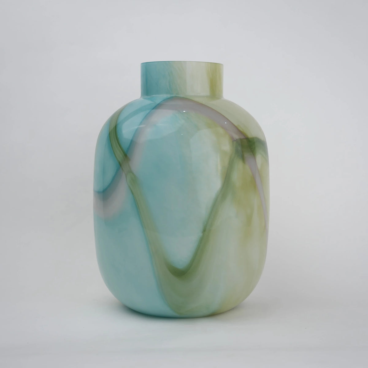 Blue marble effect glass vase with a smooth glossy finish, featuring a rounded body and short cylindrical neck, designed as a modern decorative piece for home decor styling.