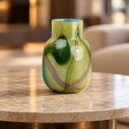 Blue marble effect glass vase with a smooth glossy finish, featuring a rounded body and short cylindrical neck, designed as a modern decorative piece for home decor styling.