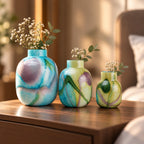 Blue marble effect glass vase with a smooth glossy finish, featuring a rounded body and short cylindrical neck, designed as a modern decorative piece for home decor styling.