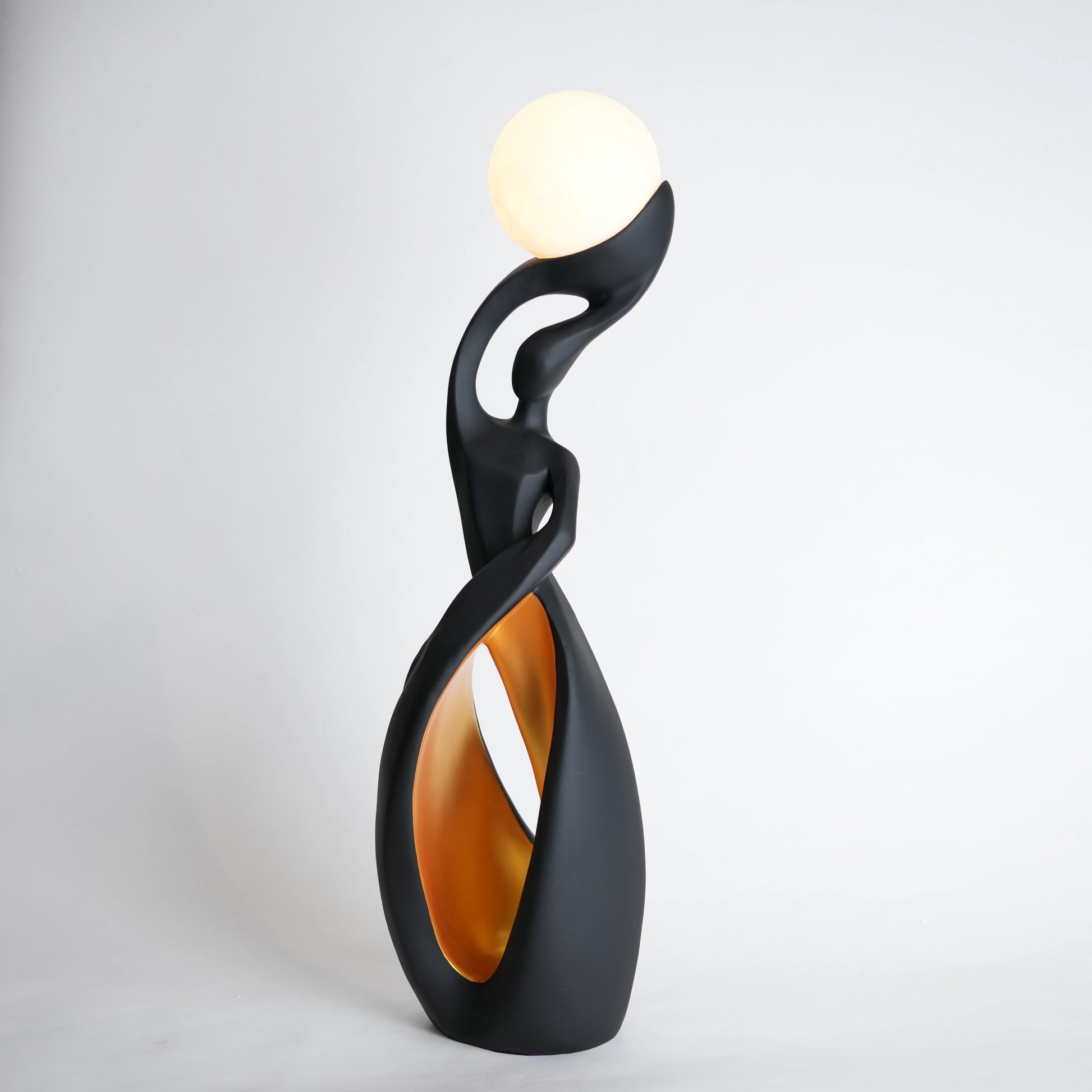 Modern black decorative lamp with a white bulb on a light gray background