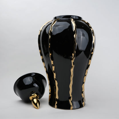 Black ceramic decorative jar with gold flowing accents and lid
