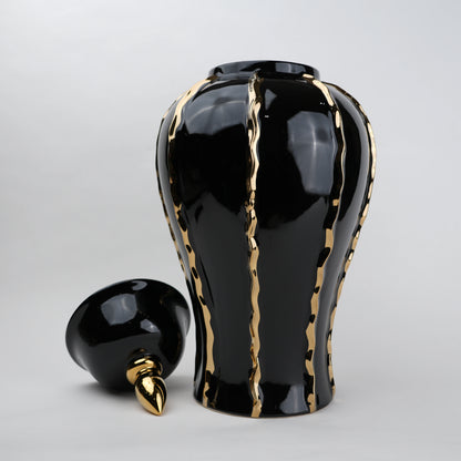 Black ceramic decorative jar with gold flowing accents and lid