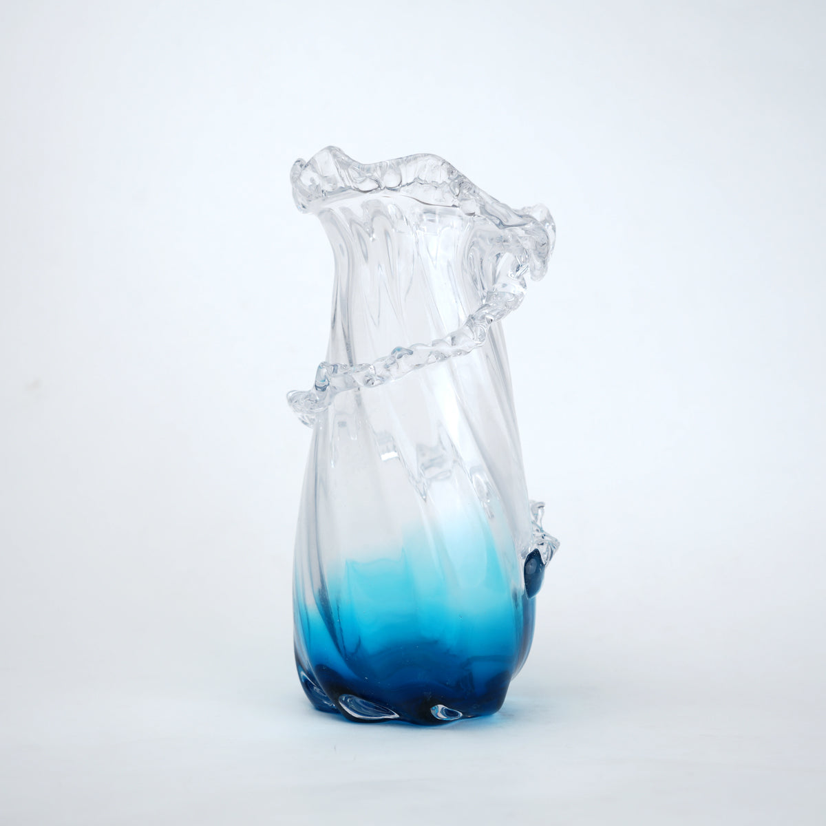 Glass vase with blue gradient on a white background